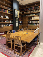 View of the Archive Reading Room with table chairs and shelves by Robert Thompson